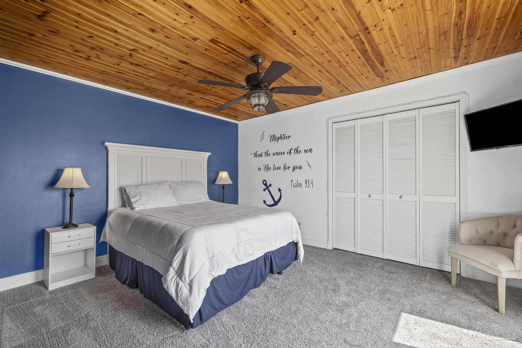 1100 Fort Pickens Road, Unit A13 Pensacola Beach, FL 32561 - Photo 35 of 63 a spacious bedroom with a bed and a chair