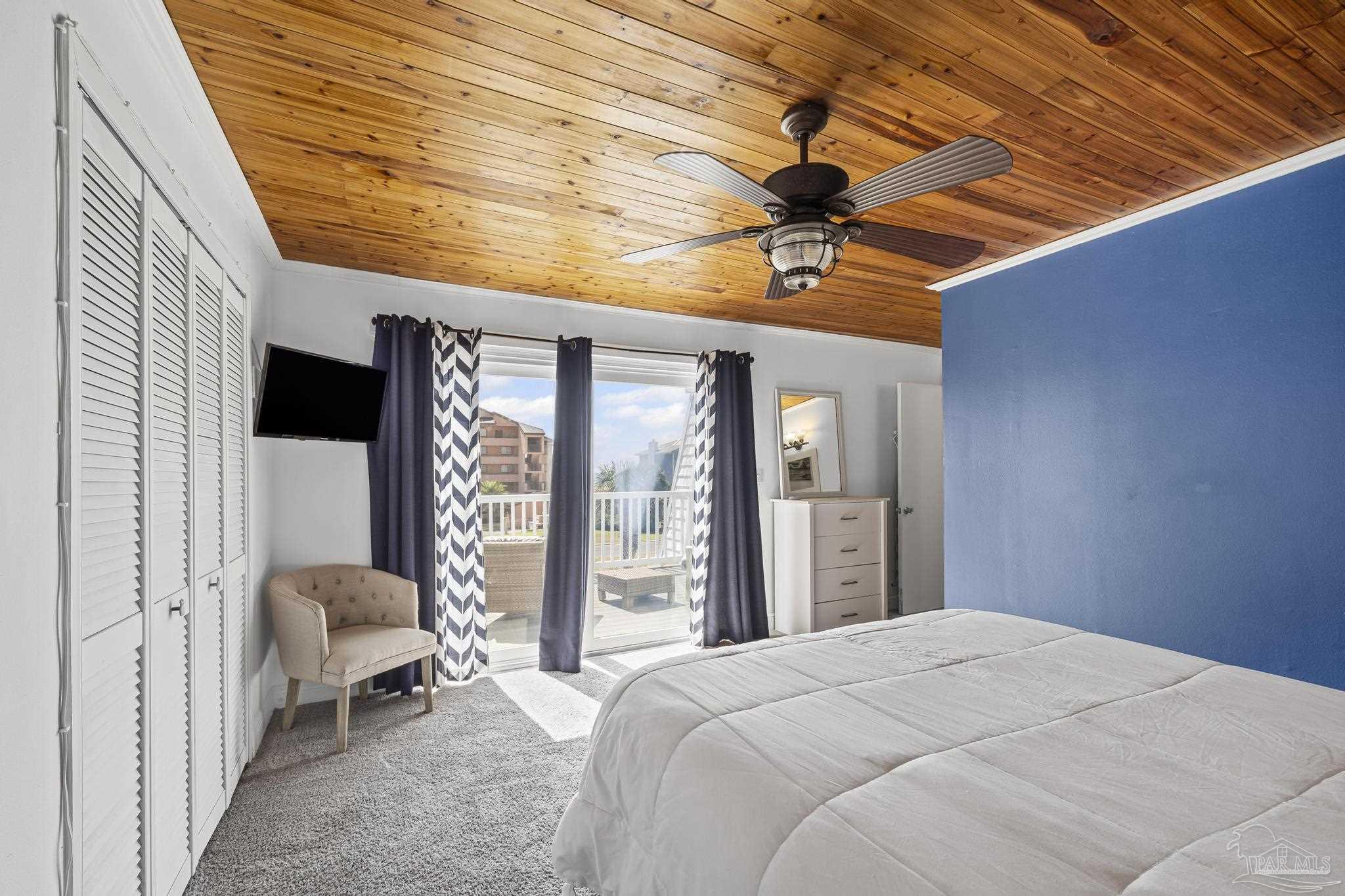 1100 Fort Pickens Road, Unit A13 Pensacola Beach, FL 32561 - Photo 36 of 63 a bedroom with a bed and a chandelier