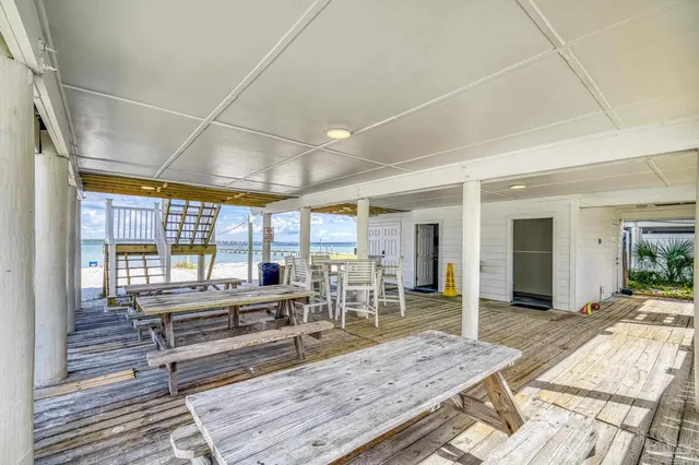 a view of a house with swimming pool and sitting area
