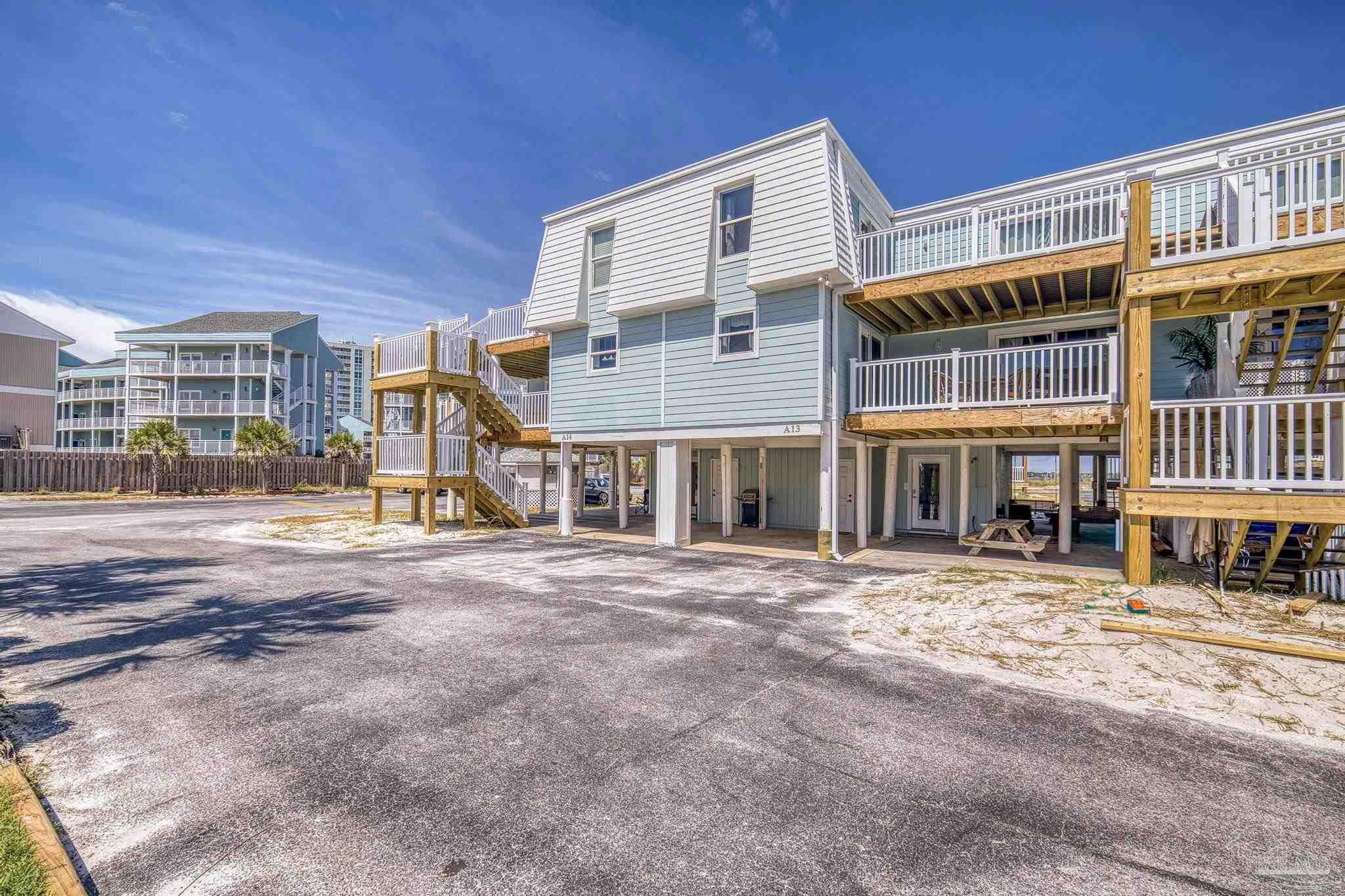 1100 Fort Pickens Road, Unit A13 Pensacola Beach, FL 32561 - Photo 7 of 63 a front view of a building with street view