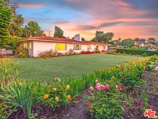 a view of a garden with a building in the background