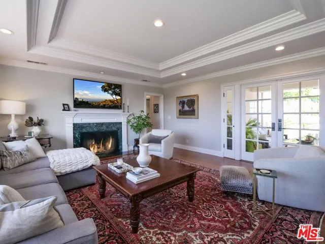 a living room with furniture a rug and a fireplace