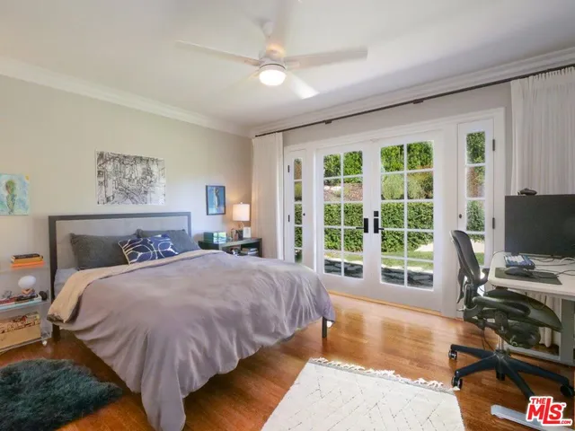 a bedroom with a bed and a computer on the desk