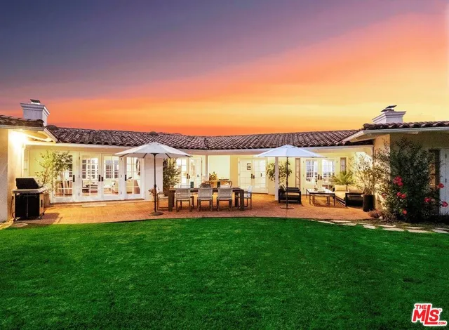 a front view of a house with a garden and patio