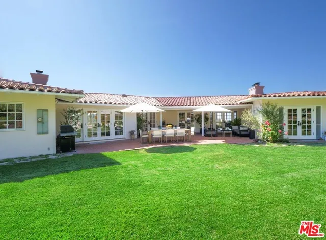 a view of house with yard and outdoor seating