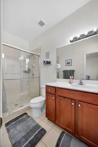 a bathroom with a sink toilet a mirror and shower