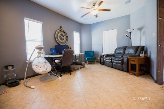 408 Acacia Street Ridgecrest, CA 93555 - Photo 15 of 32 a living room with furniture a clock and a chandelier