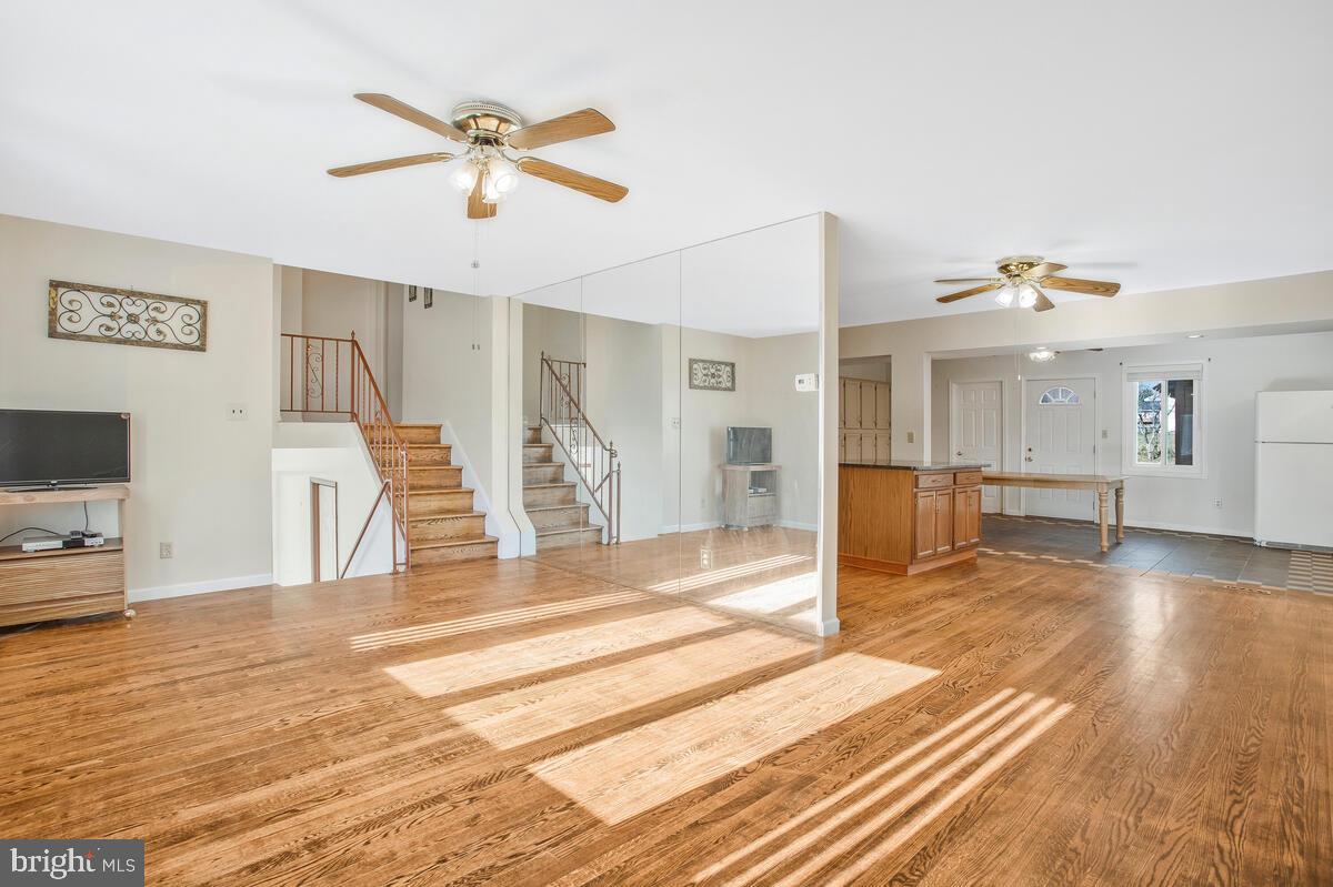 1822 Wycliffe Road Baltimore, MD 21234 - Photo 9 of 44 a view of a livingroom with wooden floor and a ceiling fan