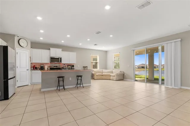 a kitchen with a refrigerator and a counter top space