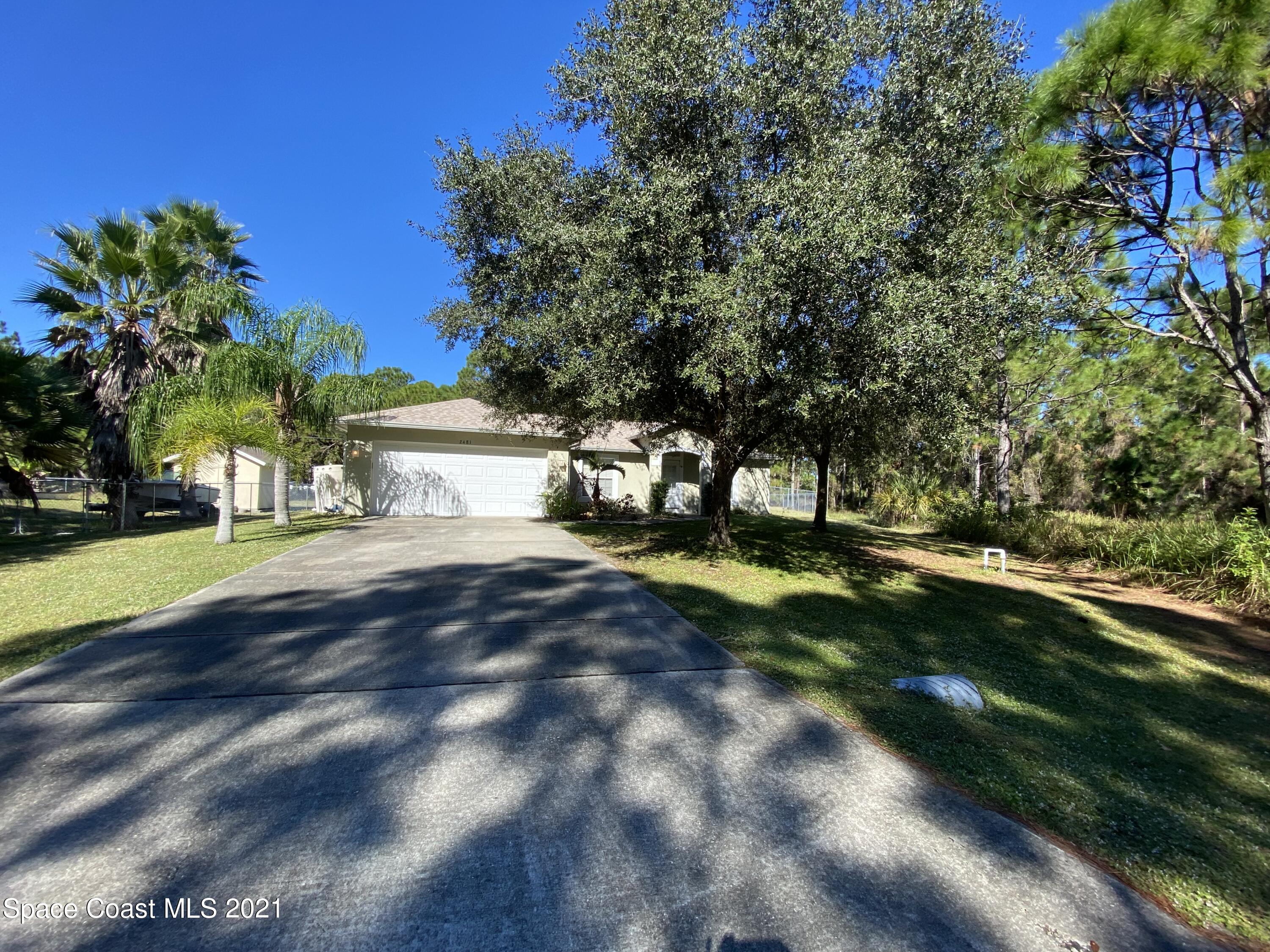 2481 Anchor Road Southeast Palm Bay, FL 32909 - Photo 2 of 32 a view of a house with a yard