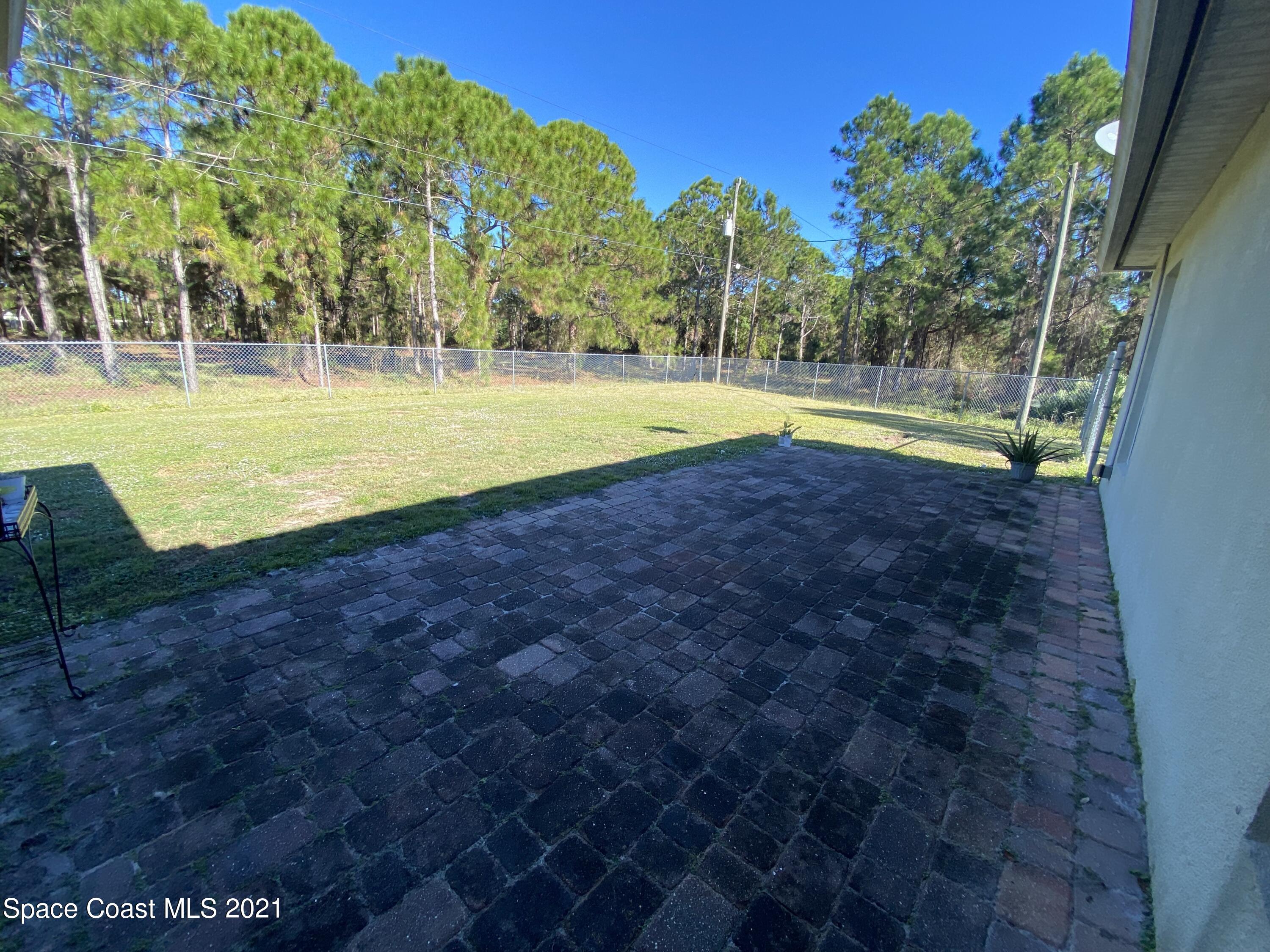 2481 Anchor Road Southeast Palm Bay, FL 32909 - Photo 12 of 32 a view of a swimming pool with a yard
