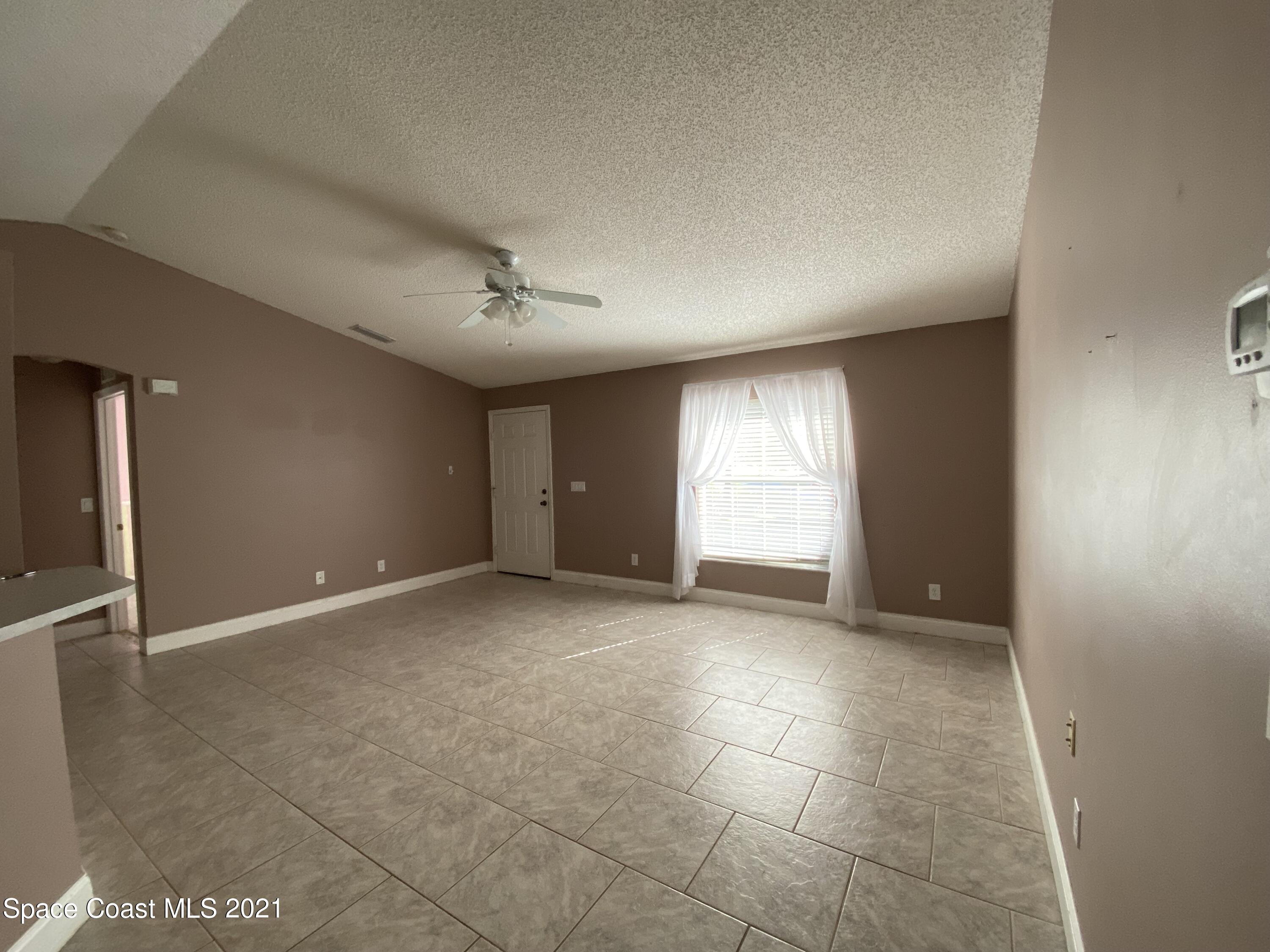 2481 Anchor Road Southeast Palm Bay, FL 32909 - Photo 13 of 32 a view of an empty room with a window