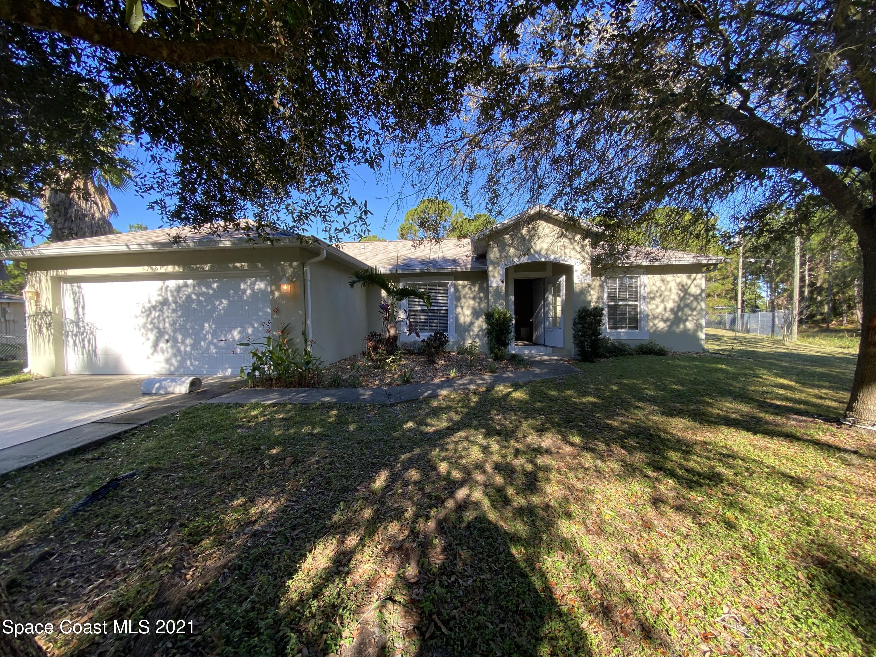 2481 Anchor Road Southeast Palm Bay, FL 32909 - Photo 3 of 32 a front view of a house with a yard