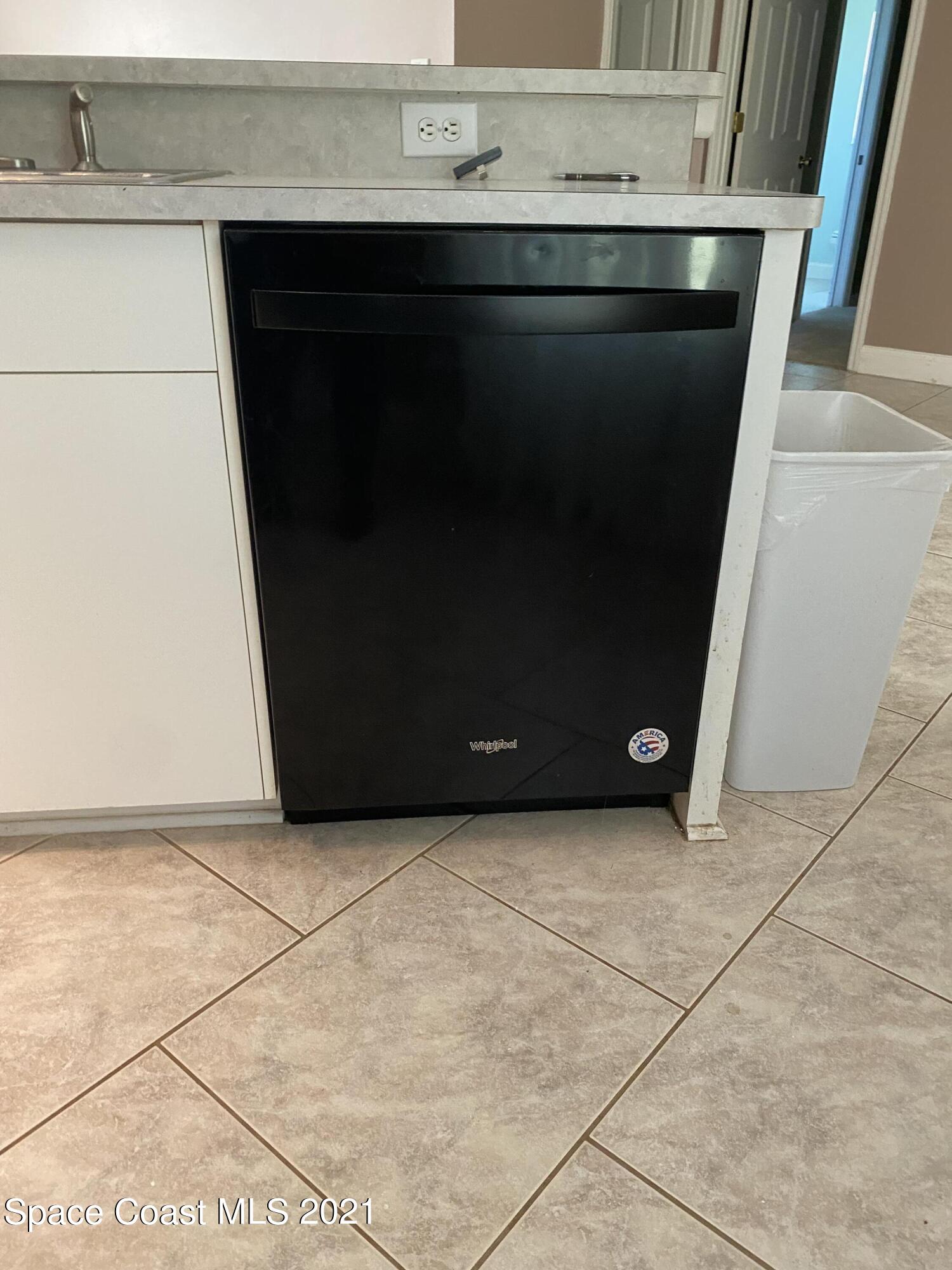 2481 Anchor Road Southeast Palm Bay, FL 32909 - Photo 21 of 32 a stove top oven sitting inside of a kitchen