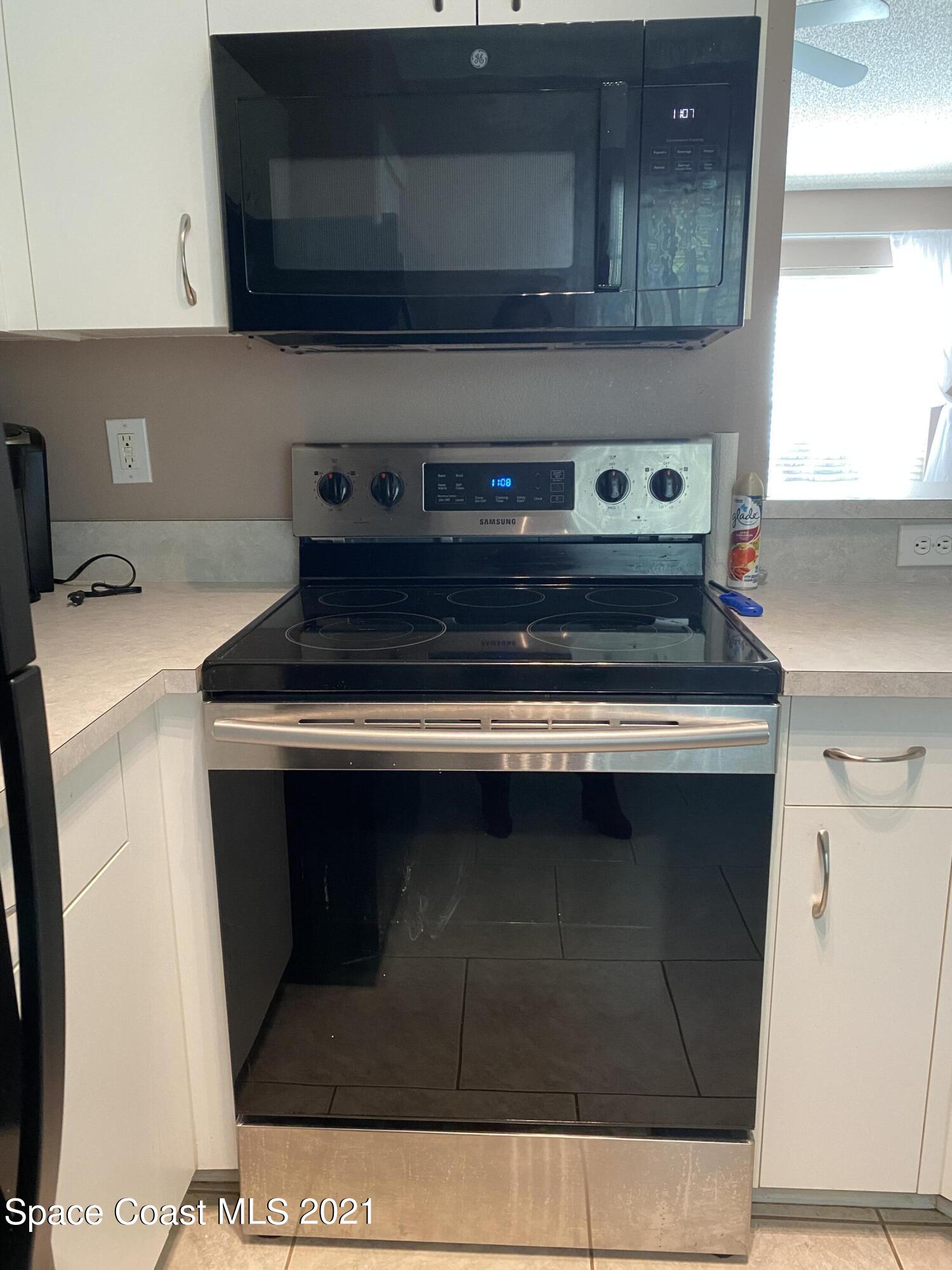 2481 Anchor Road Southeast Palm Bay, FL 32909 - Photo 22 of 32 a stove top oven sitting inside of a kitchen