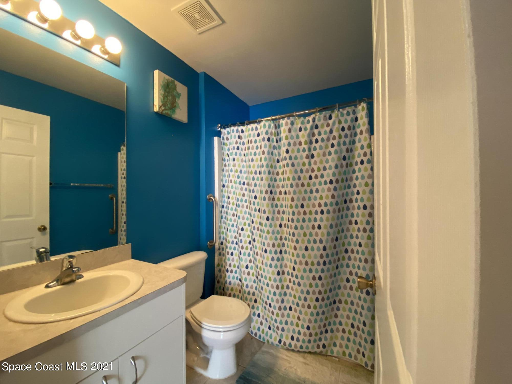 2481 Anchor Road Southeast Palm Bay, FL 32909 - Photo 30 of 32 a bathroom with a sink a toilet and shower