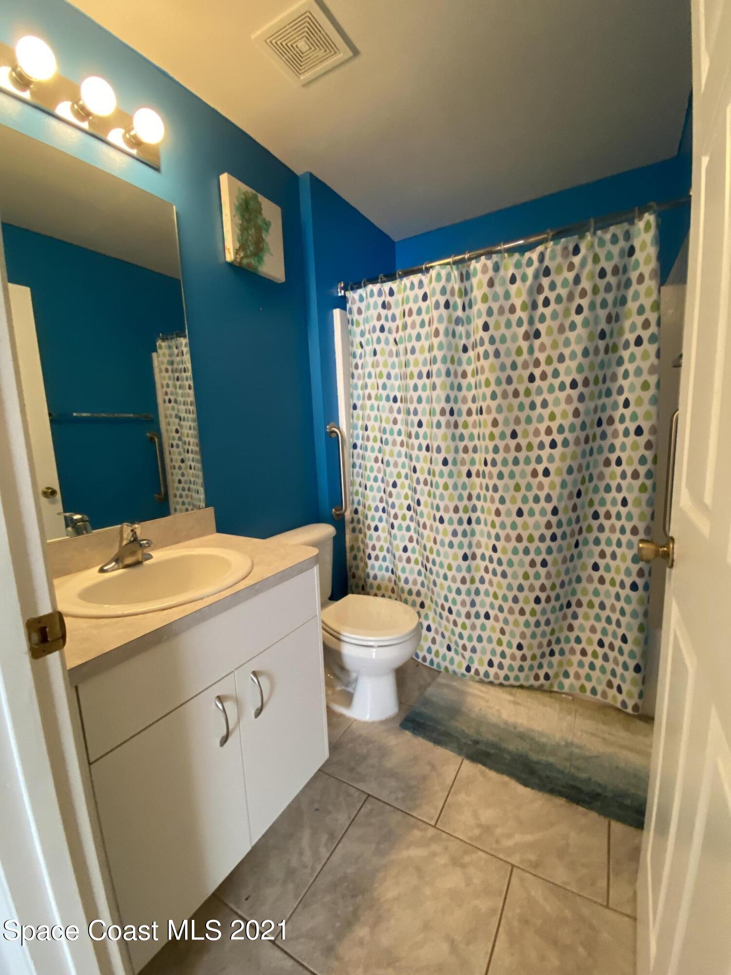 2481 Anchor Road Southeast Palm Bay, FL 32909 - Photo 31 of 32 a bathroom with a sink toilet and shower