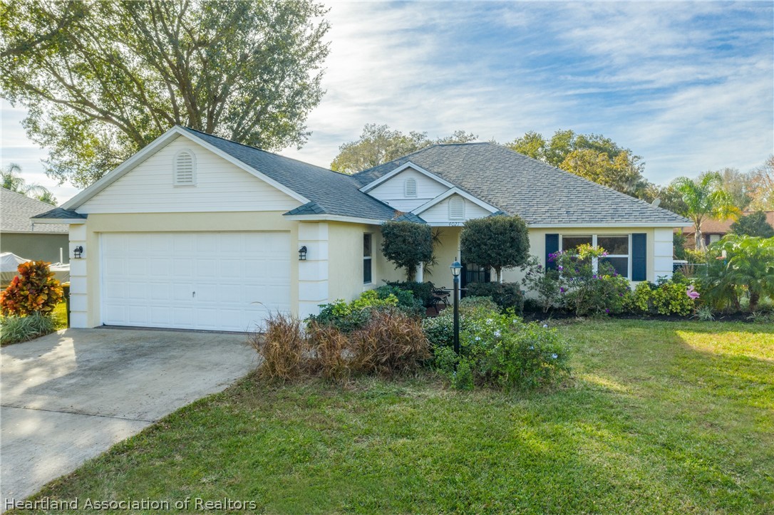 4021 Loquat Road Sebring, FL 33875 - Photo 1 of 26 a front view of a house with garden