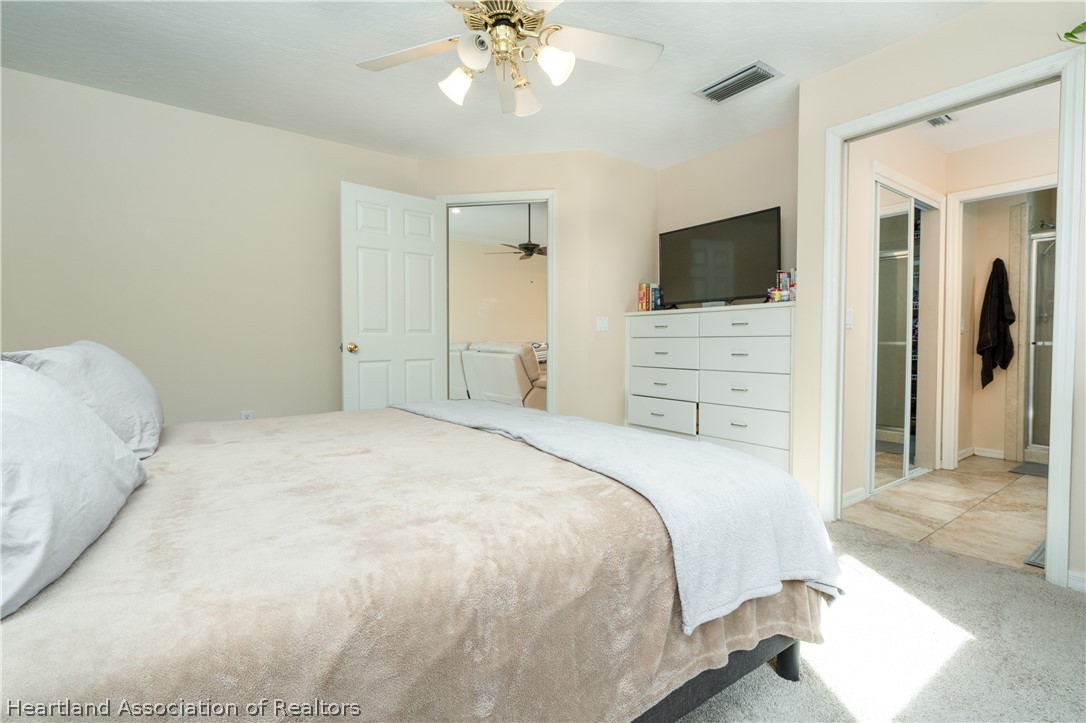 4021 Loquat Road Sebring, FL 33875 - Photo 12 of 26 a bedroom with a bed and a flat screen tv
