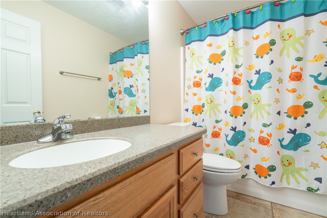 4021 Loquat Road Sebring, FL 33875 - Photo 16 of 26 a bathroom with a sink and a mirror