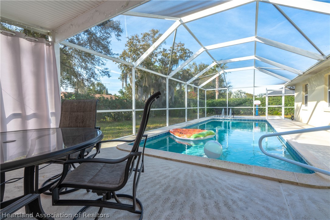 4021 Loquat Road Sebring, FL 33875 - Photo 21 of 26 a view of a chairs and table in the patio