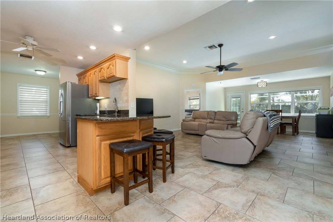 4021 Loquat Road Sebring, FL 33875 - Photo 5 of 26 a living room with couches and kitchen view with kitchen view