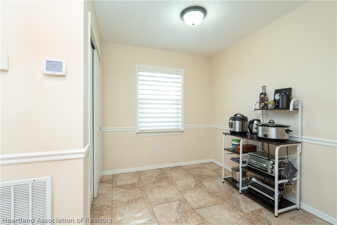 4021 Loquat Road Sebring, FL 33875 - Photo 8 of 26 a room that has a dresser and a window in it