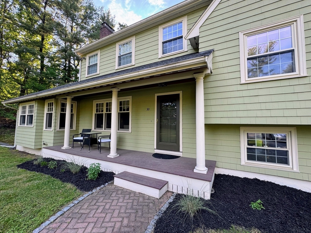 30 Oxbow Road Lexington, MA 02421 - Photo 26 of 30 a front view of a house with outdoor seating and barbeque oven