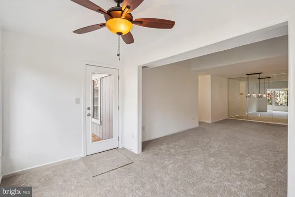 a view of a livingroom with wooden floor and a window