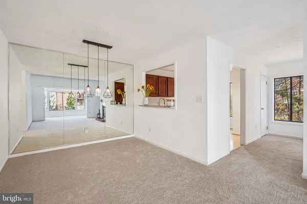 an empty room with a empty space and windows