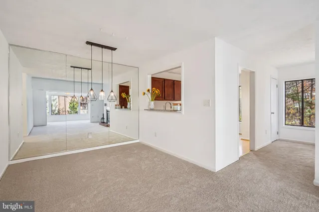 an empty room with a empty space and windows