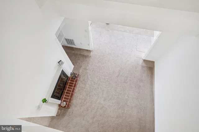 en empty room with windows and fan