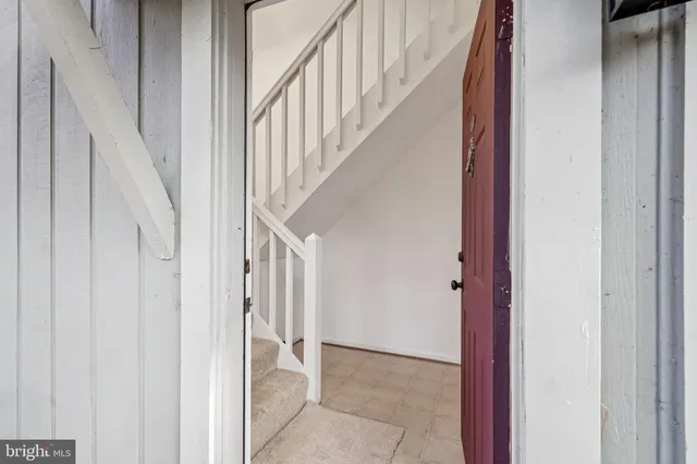 a living room with furniture and stairs