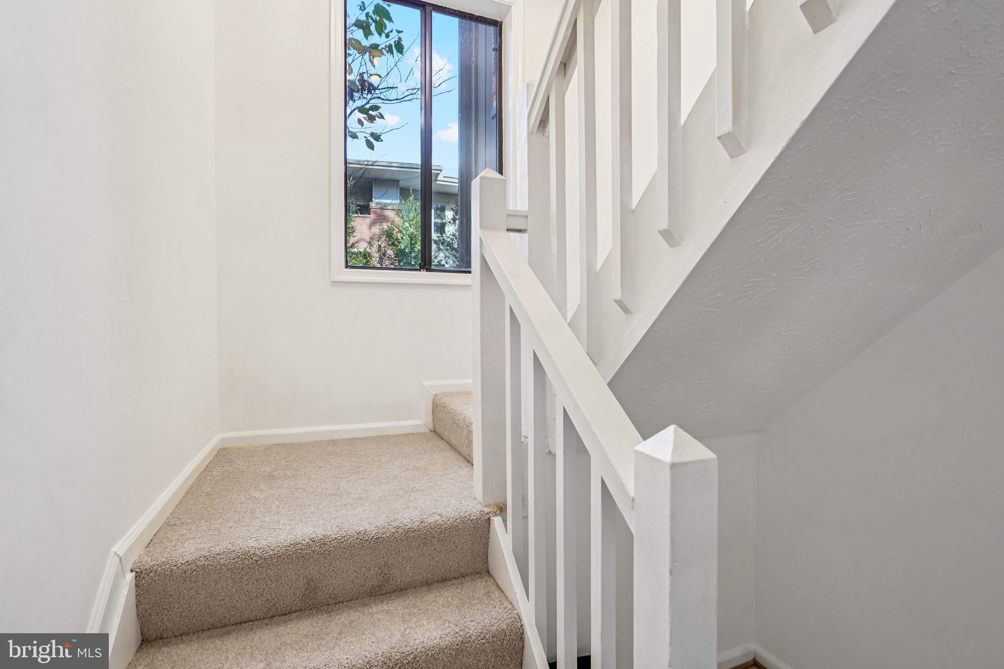 2203 Hunter's Run Drive Reston, VA 20191 - Photo 22 of 48 a living room with furniture and stairs