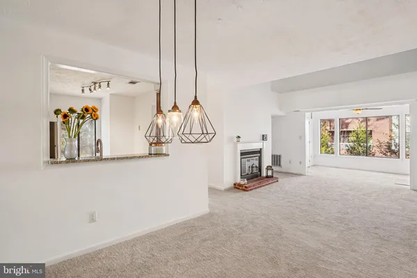 a view of a livingroom with a fireplace and workspace