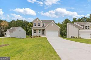 343 Shoals Trail Dallas, GA 30132 - Photo 2 of 10 a front view of a house with a yard and garage