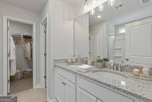 343 Shoals Trail Dallas, GA 30132 - Photo 8 of 10 a bathroom with a granite countertop sink double and mirror
