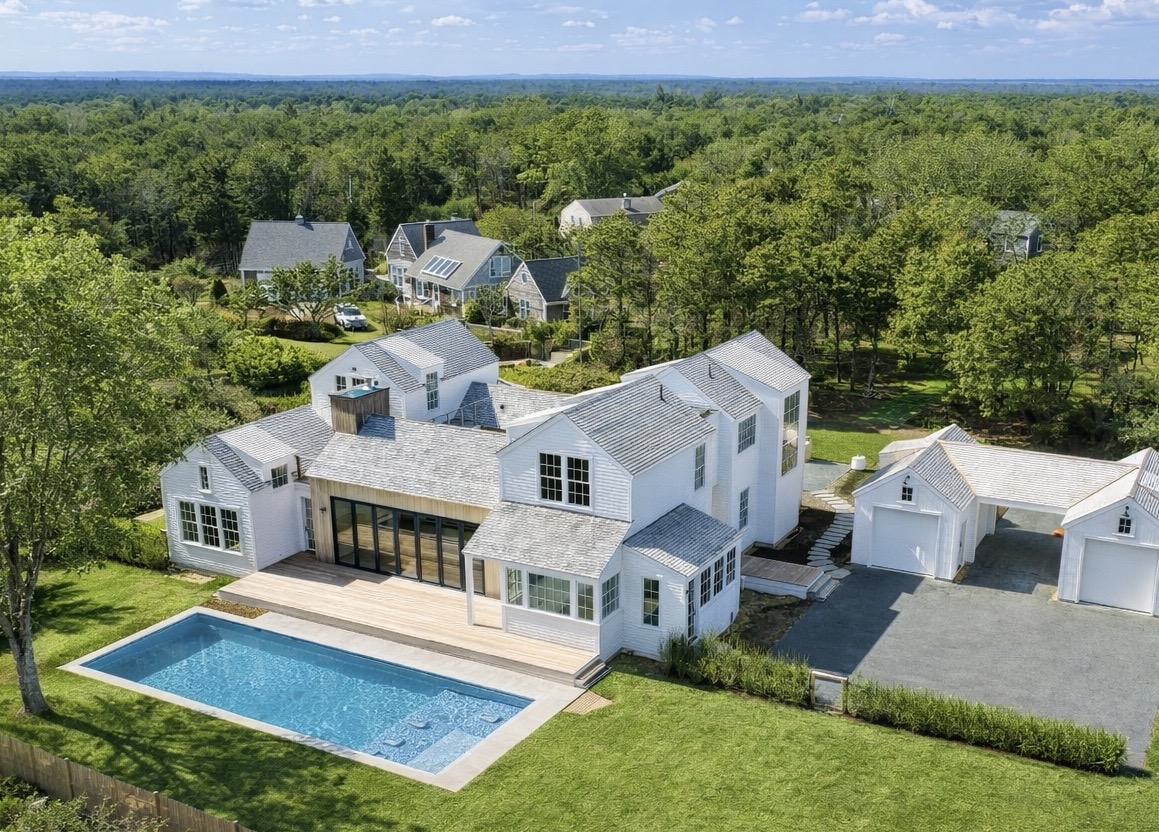 an aerial view of a house with swimming pool garden and mountain view
