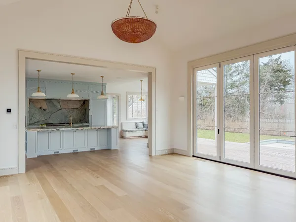 a kitchen with granite countertop a stove and a wooden floors