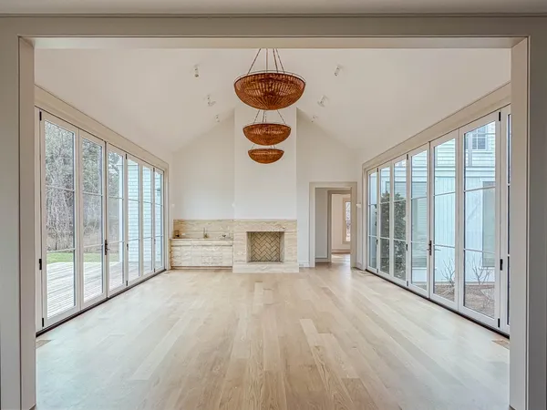 an empty room with windows and closet