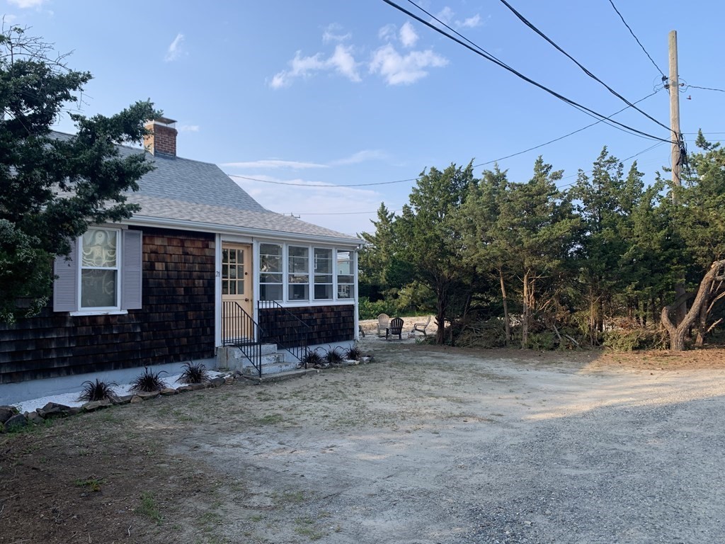 21 Postscript Lane Scituate, MA 02050 - Photo 1 of 1 a view of a house with a yard and sitting area