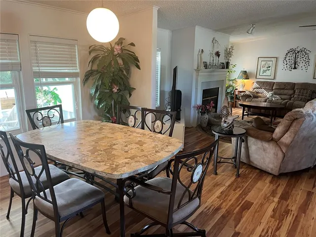 a dining room with furniture and wooden floor