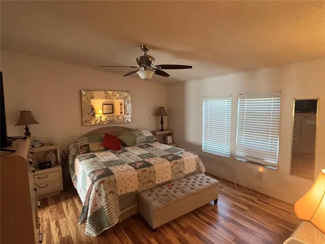 a bedroom with a bed a dresser and a window