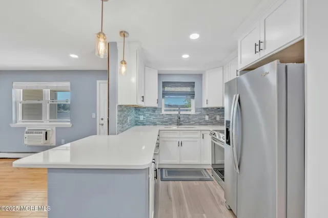 a kitchen with stainless steel appliances a refrigerator sink and microwave