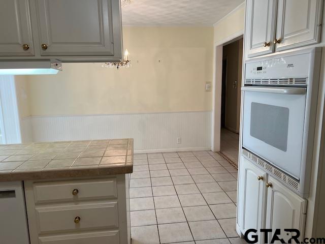 216 Arch Davis Road Pittsburg, TX 75686 - Photo 2 of 20 a view of a kitchen with white cabinets and appliances