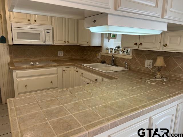 216 Arch Davis Road Pittsburg, TX 75686 - Photo 3 of 20 a kitchen with a sink a stove and cabinets