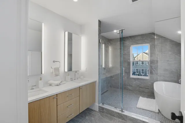 a bathroom with a shower sink and mirror