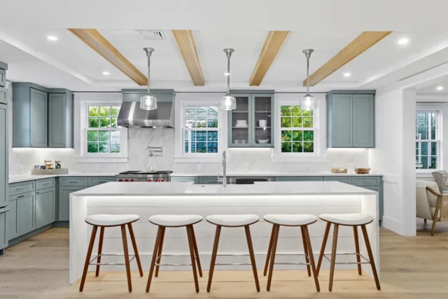 a kitchen with a table chairs sink and cabinets