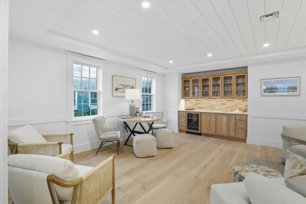 a living room with furniture a window and a wooden floor