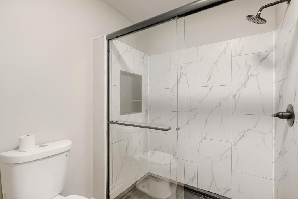 2021 Irwin Bridge Road Northwest Conyers, GA 30012 - Photo 30 of 43 a bathroom with a shower and toilet